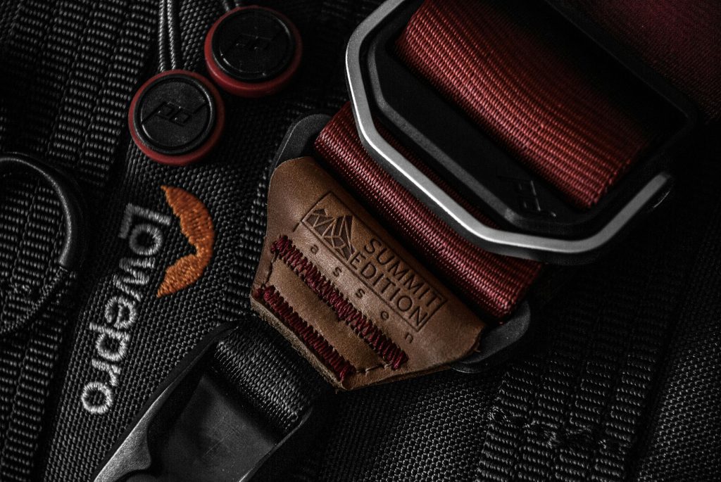 Close up of a professional camera bag strap, illustrating the necessity of High Value Item Protection for specialized travel gear.